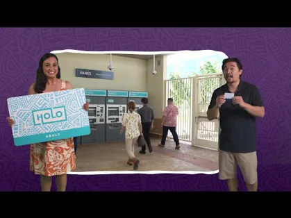 A woman and a man holding replicas of the HOLO pass